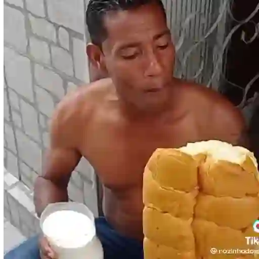 Figurinha: Homem com pão e copo de leite