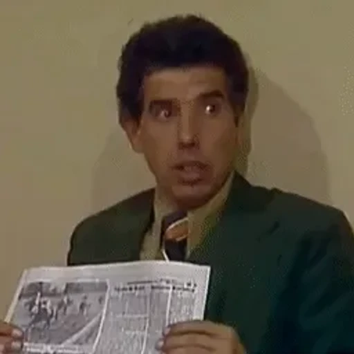 Figurinha: Homem lê jornal com espanto