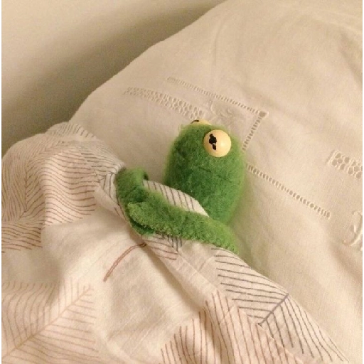 Figurinha: Sapo de pelúcia na cama