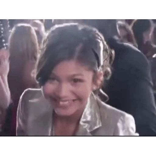 Figurinha: Zendaya acenando e sorrindo
